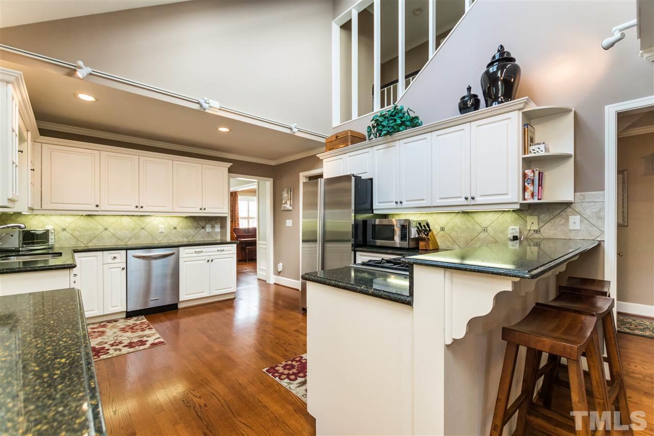 1422 Canterbury Road Raleigh, NC 27608 - Photo 10 of 25 a kitchen with stainless steel appliances granite countertop a sink refrigerator and cabinets