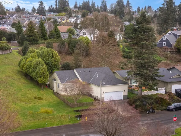 an aerial view of a house with garden space and street view