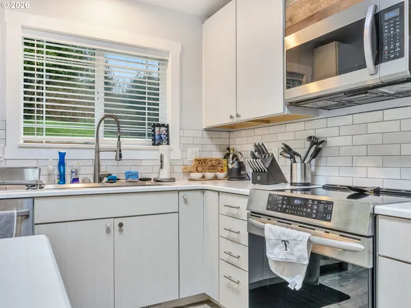a kitchen with appliances cabinets and a sink