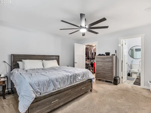 a bedroom with bed and a chandelier