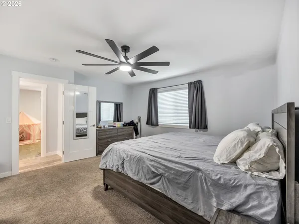 a bedroom with a large bed and a chandelier