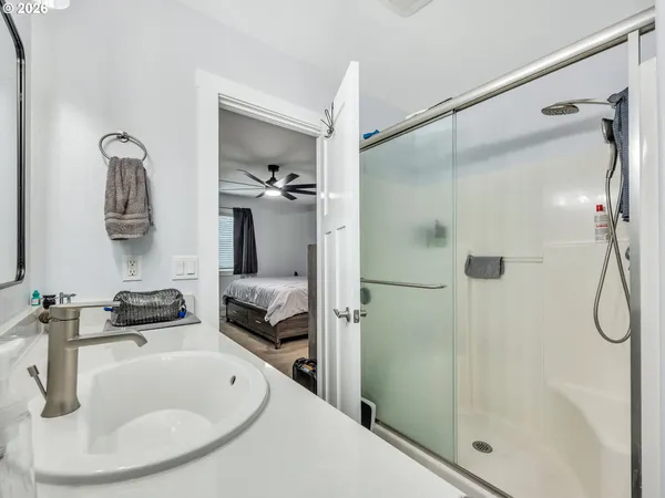 a bathroom with a tub shower vanity and a sink