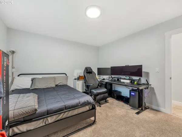 a view of a workspace with furniture and a flat screen tv