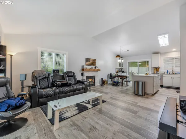 a living room with furniture flat screen tv and a table