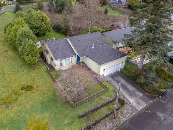 an aerial view of a house with a yard
