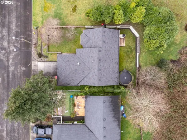 an aerial view of residential houses with outdoor space and swimming pool