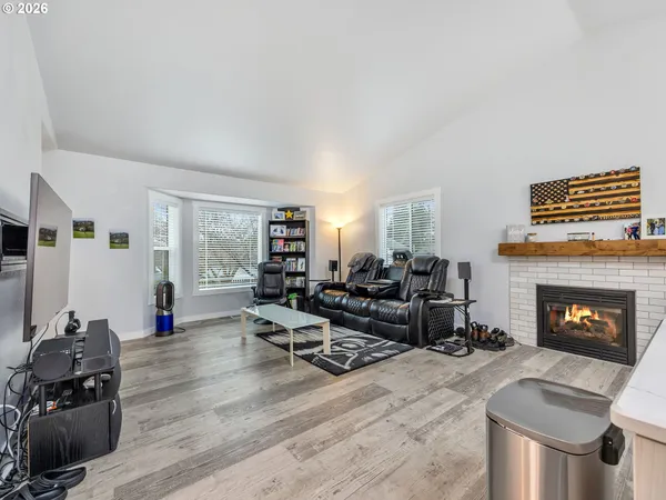 a living room with furniture wooden floor and a fireplace