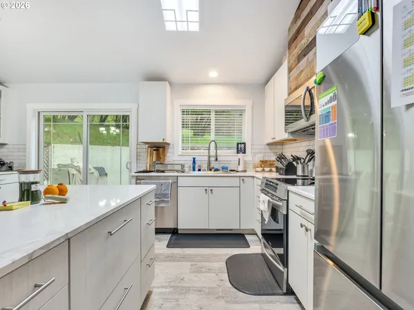 a kitchen with a sink stove and cabinets
