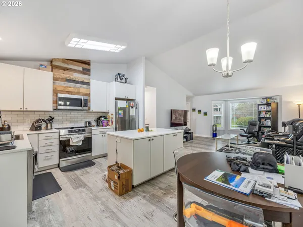 a kitchen with a refrigerator cabinets and furniture