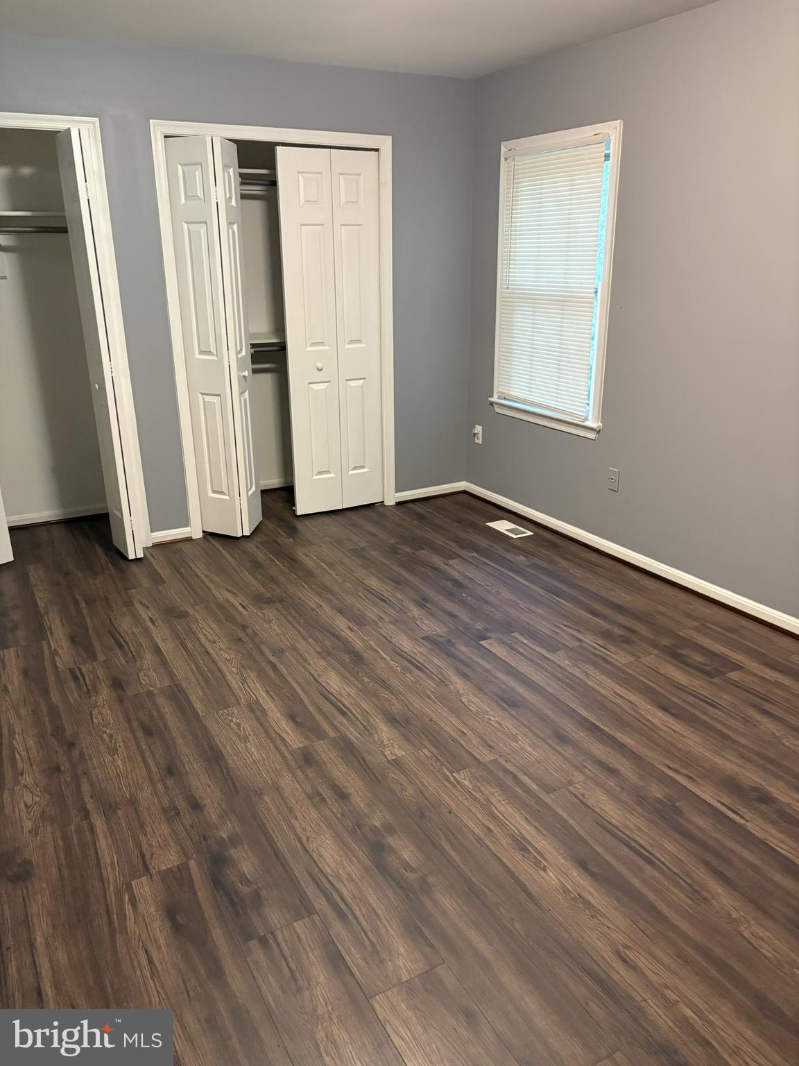 13242 Stravinsky Terrace Silver Spring, MD 20904 - Photo 5 of 11 an empty room with wooden floor and windows