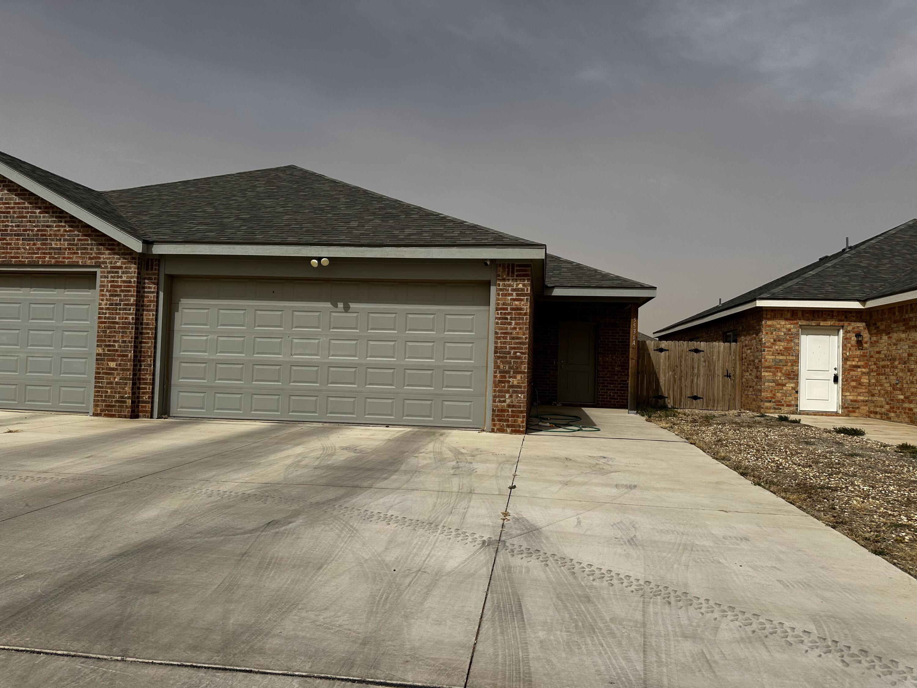 5536 Itasca Street, Unit A Lubbock, TX 79416 - Photo 1 of 1 a front view of a house with a yard and garage