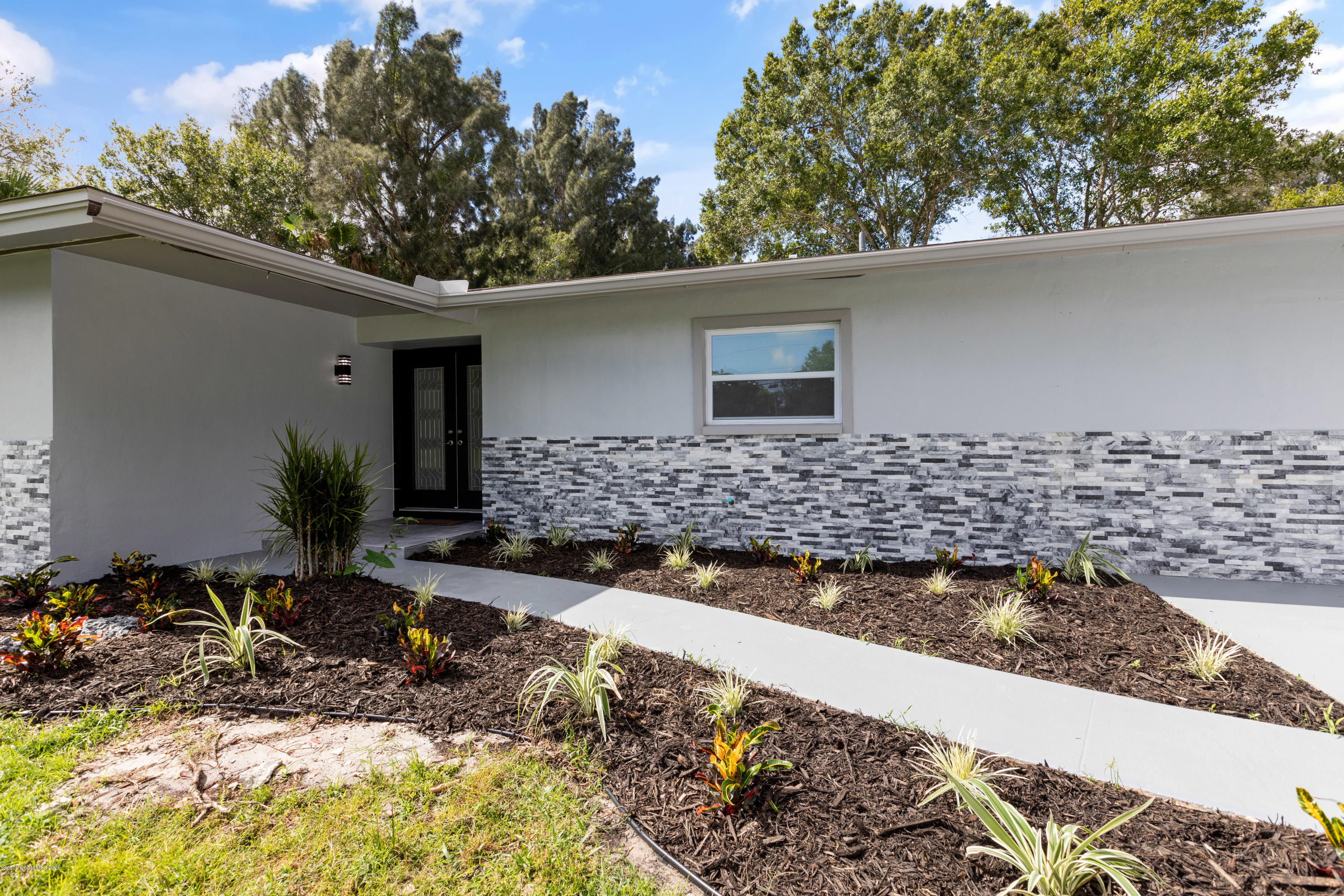 1790 Harlock Road Melbourne, FL 32934 - Photo 1 of 47 a front view of a house with trees