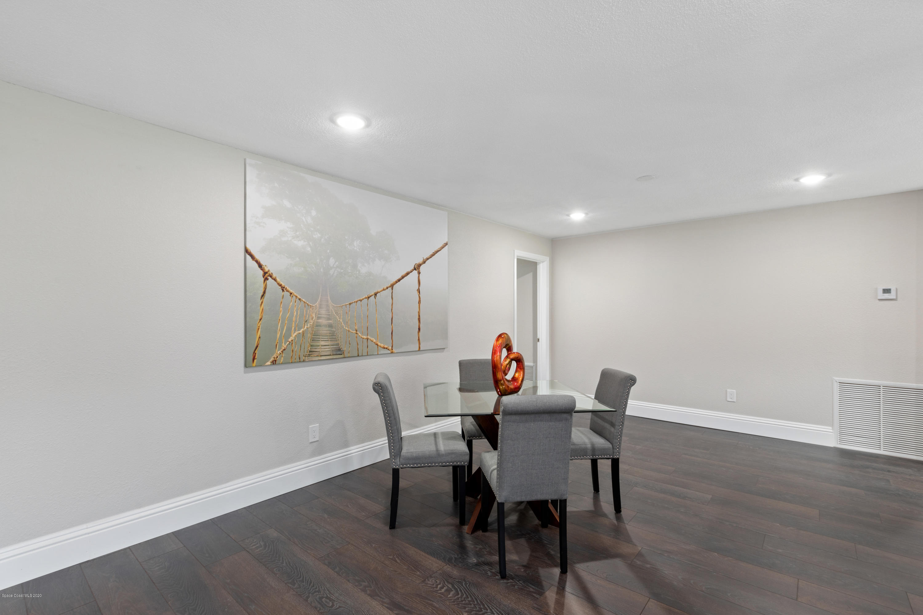 1790 Harlock Road Melbourne, FL 32934 - Photo 12 of 47 a view of a dining room with furniture and wooden floor