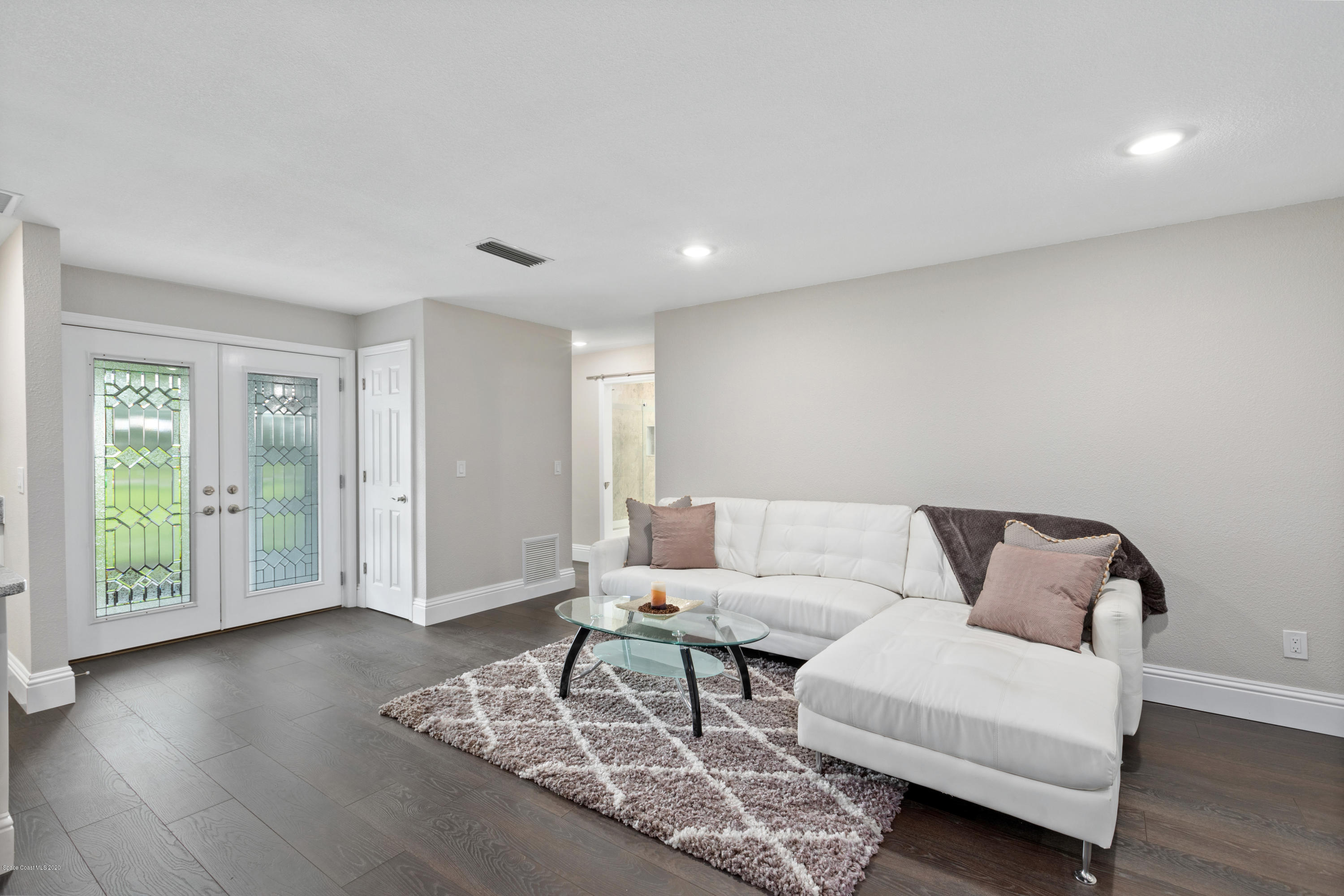 1790 Harlock Road Melbourne, FL 32934 - Photo 13 of 47 a living room with furniture and a wooden floor
