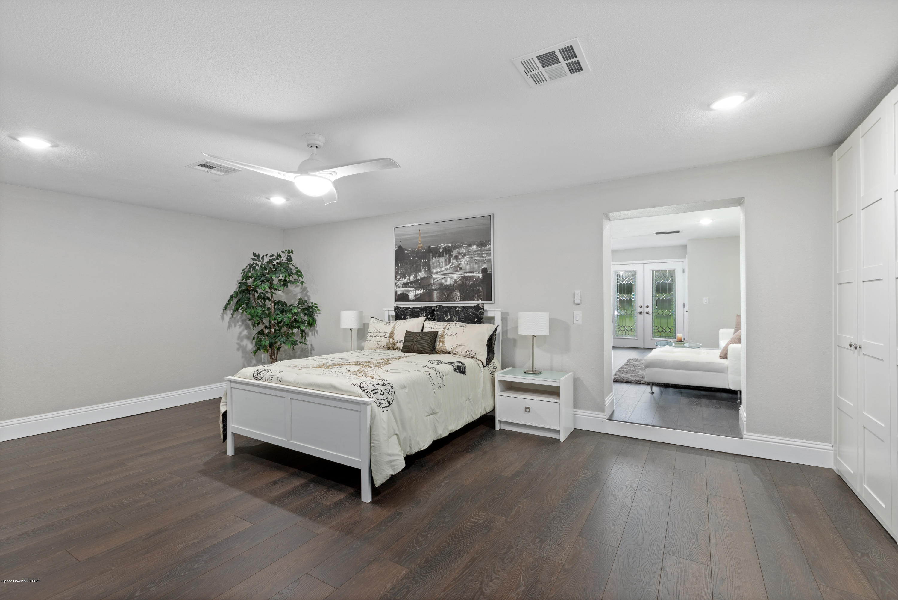 1790 Harlock Road Melbourne, FL 32934 - Photo 21 of 47 a spacious bedroom with a bed and wooden floor