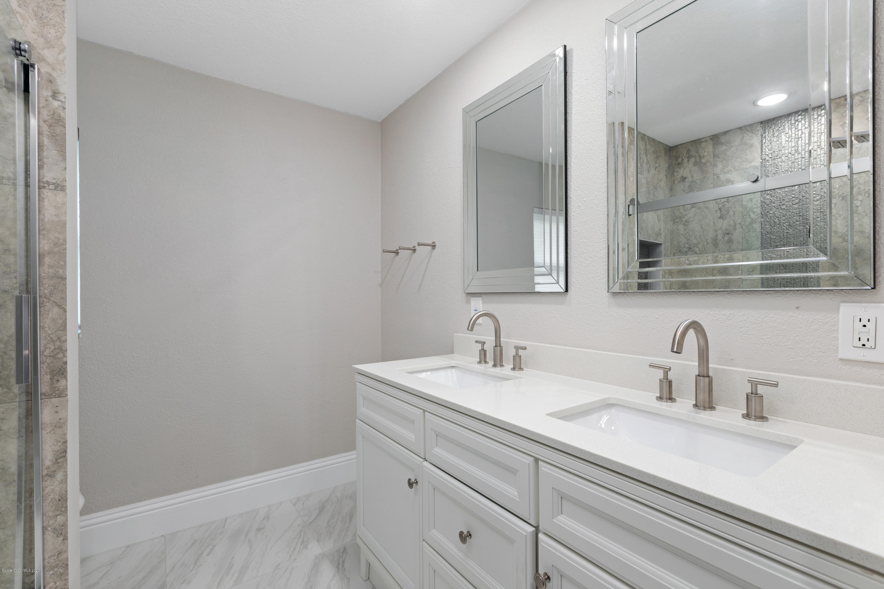 1790 Harlock Road Melbourne, FL 32934 - Photo 23 of 47 a bathroom with a sink and a mirror