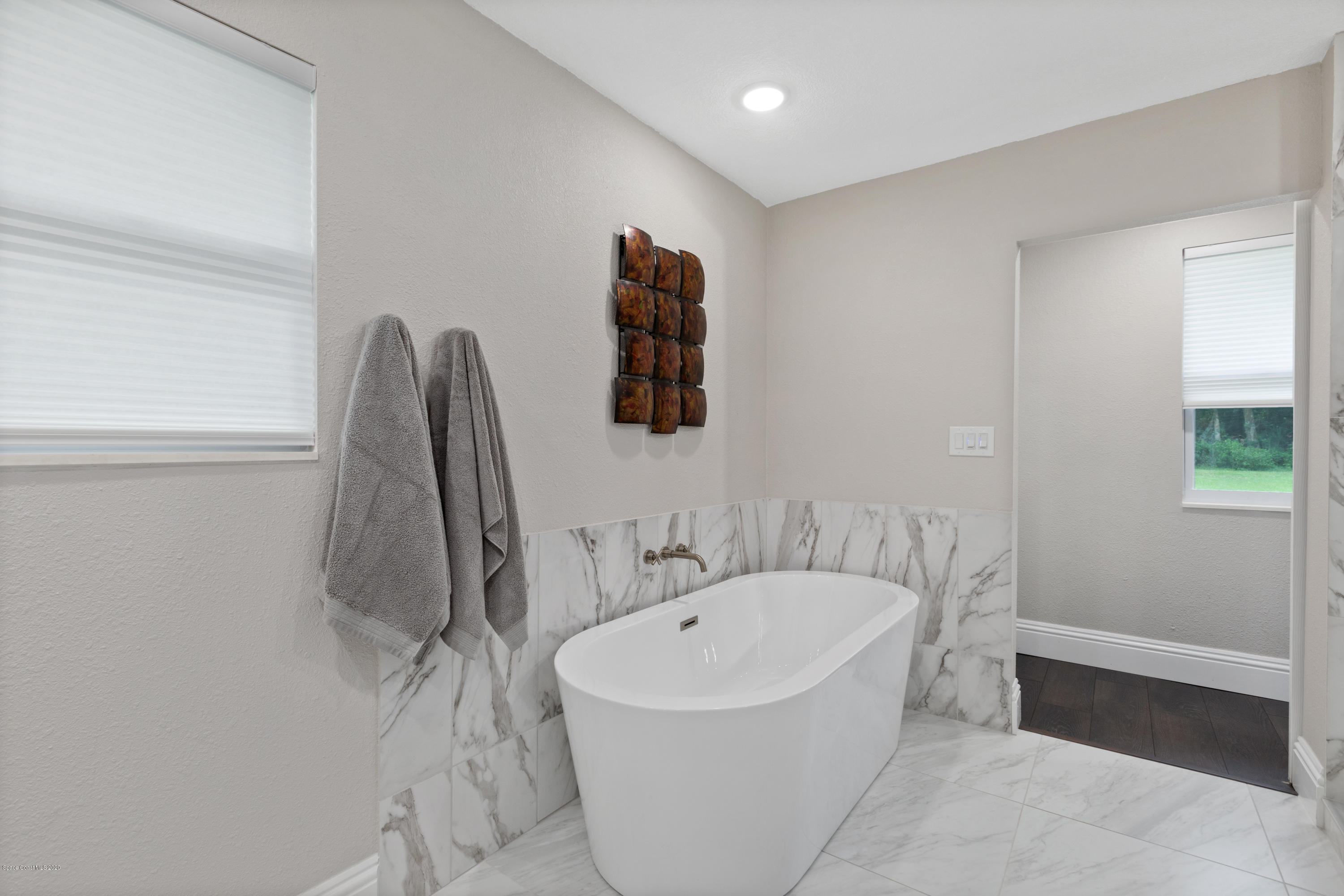 1790 Harlock Road Melbourne, FL 32934 - Photo 24 of 47 a white bath tub sitting next to a white sink and vanity