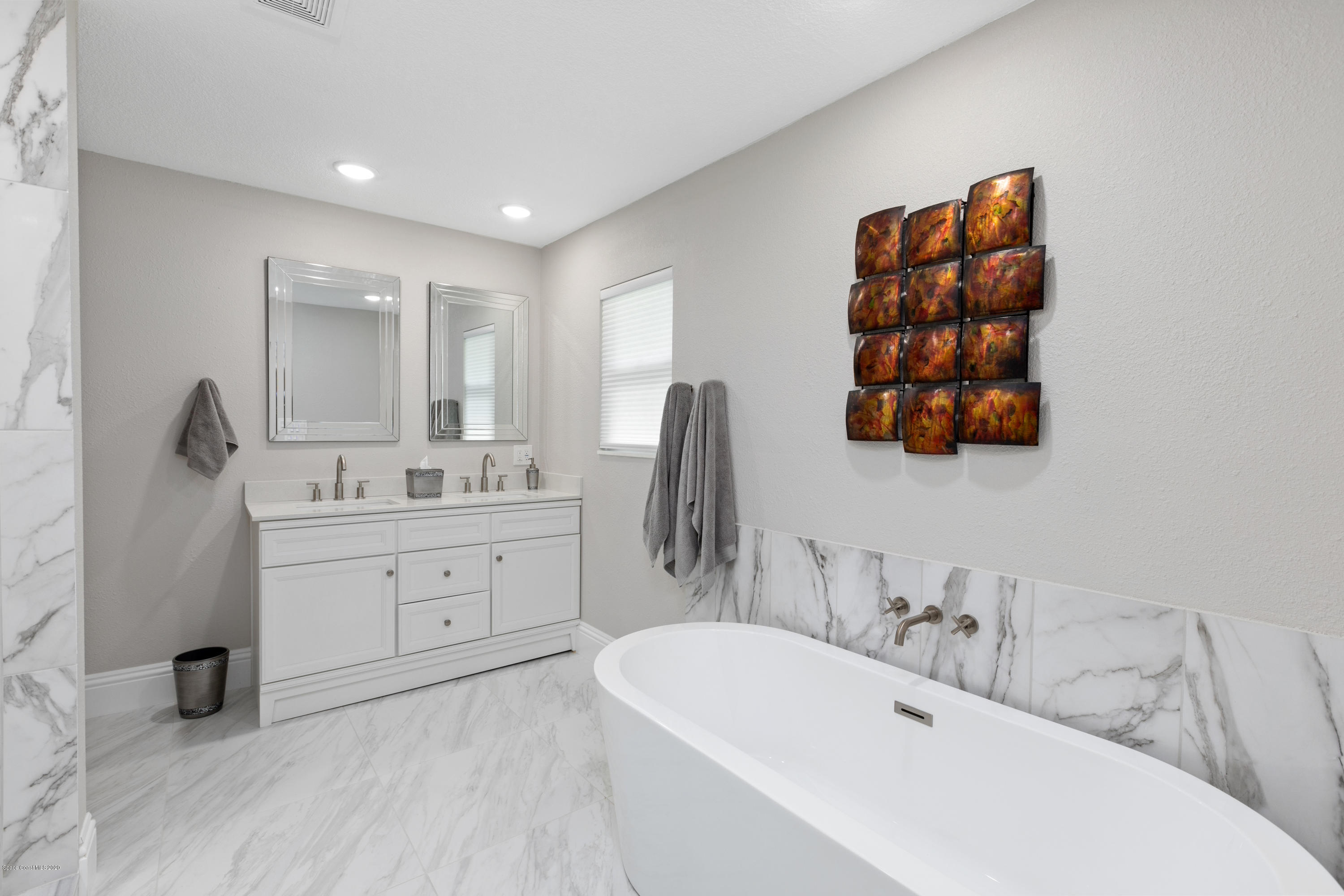 1790 Harlock Road Melbourne, FL 32934 - Photo 25 of 47 a bathroom with a double vanity sink mirror and bathtub