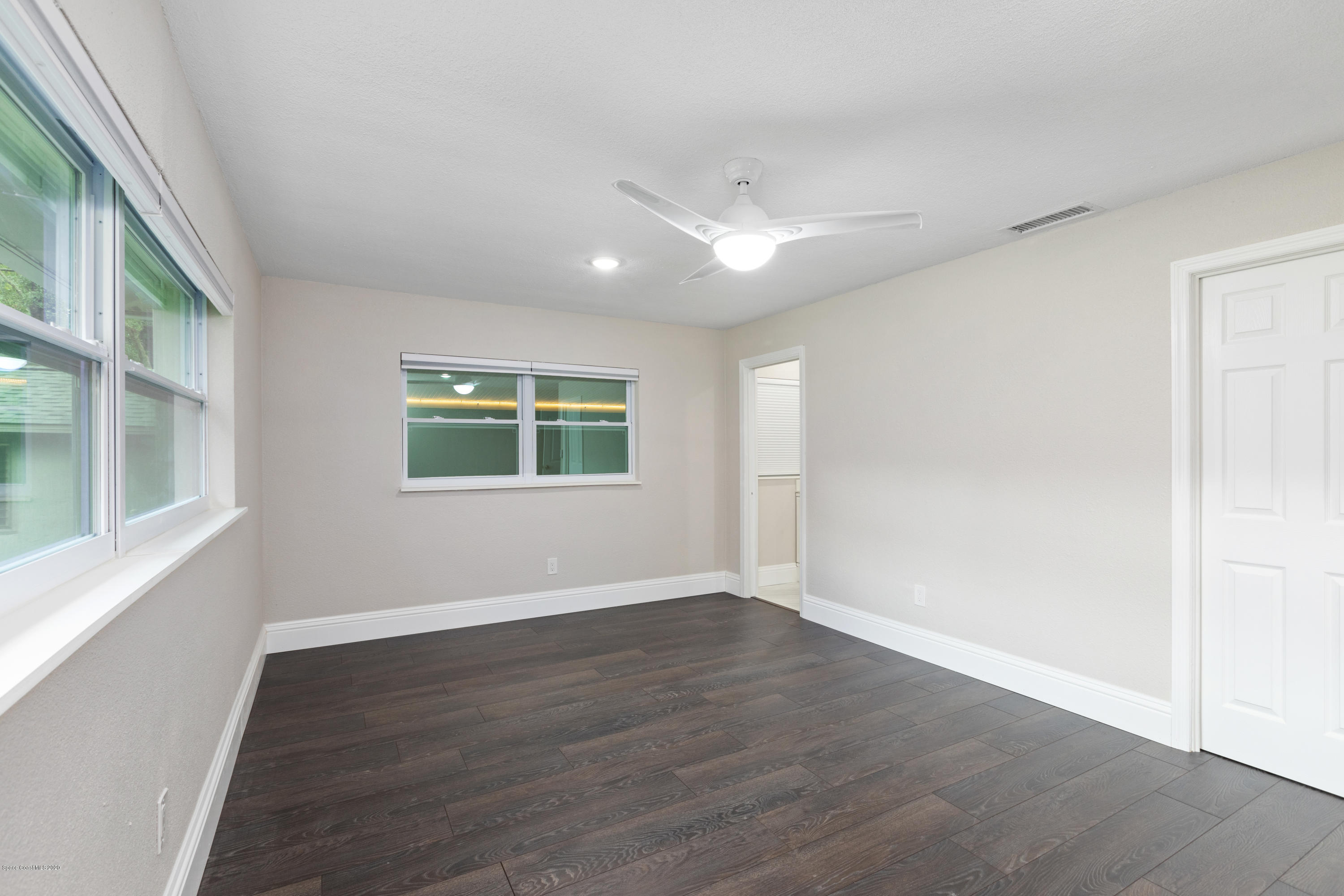 1790 Harlock Road Melbourne, FL 32934 - Photo 27 of 47 a view of an empty room with wooden floor and a window