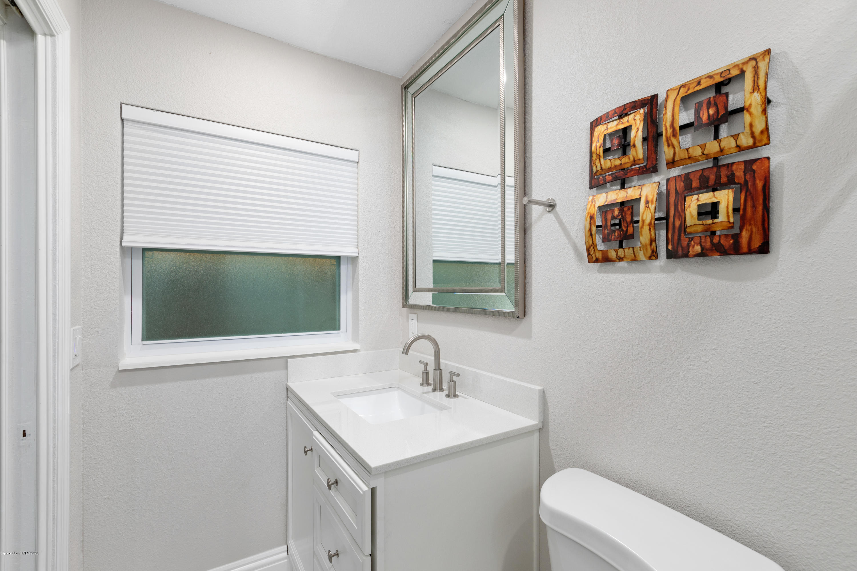 1790 Harlock Road Melbourne, FL 32934 - Photo 30 of 47 a bathroom with a sink and a mirror