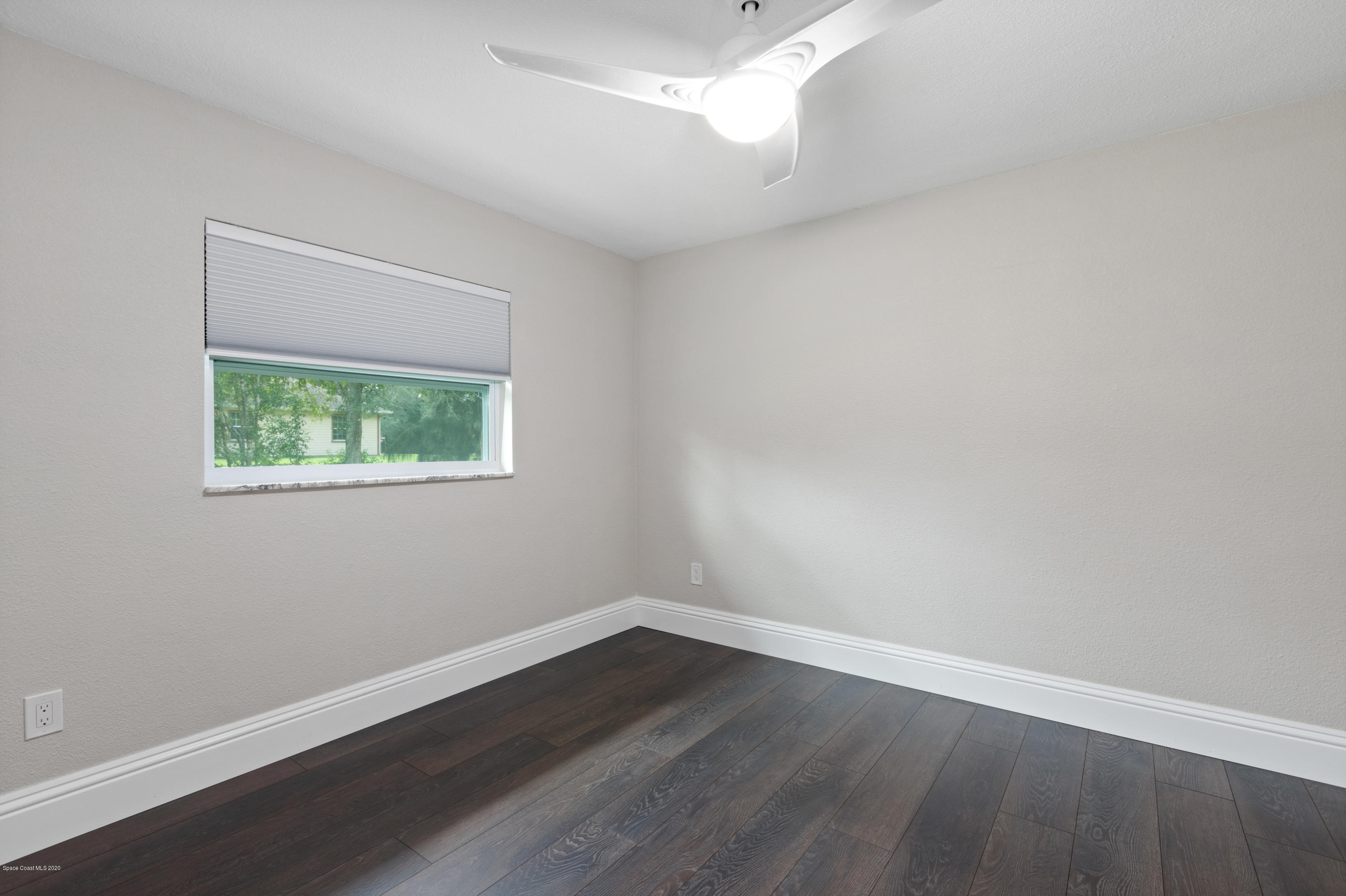 1790 Harlock Road Melbourne, FL 32934 - Photo 32 of 47 an empty room with wooden floor and window