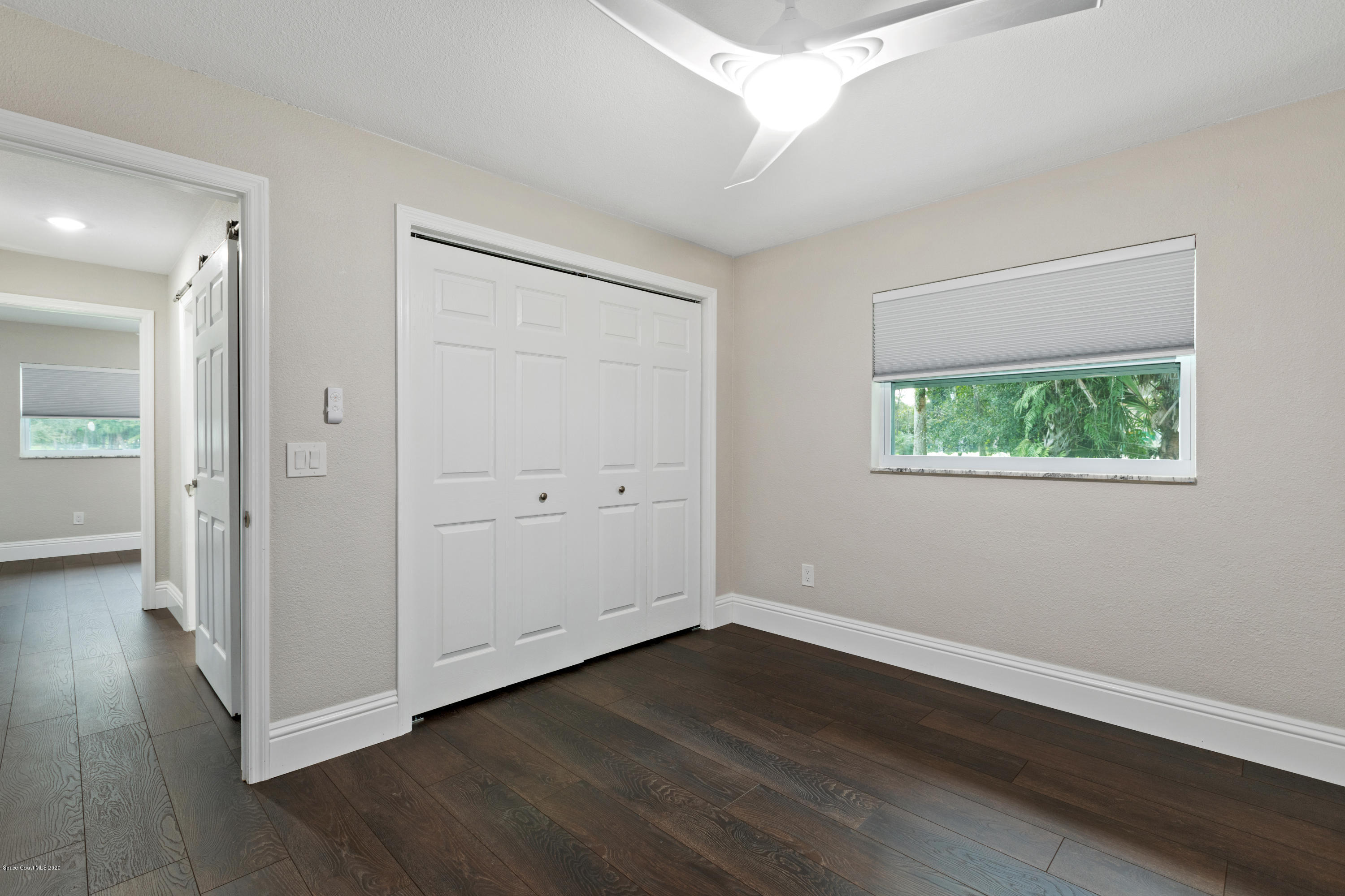 1790 Harlock Road Melbourne, FL 32934 - Photo 33 of 47 an empty room with wooden floor and windows