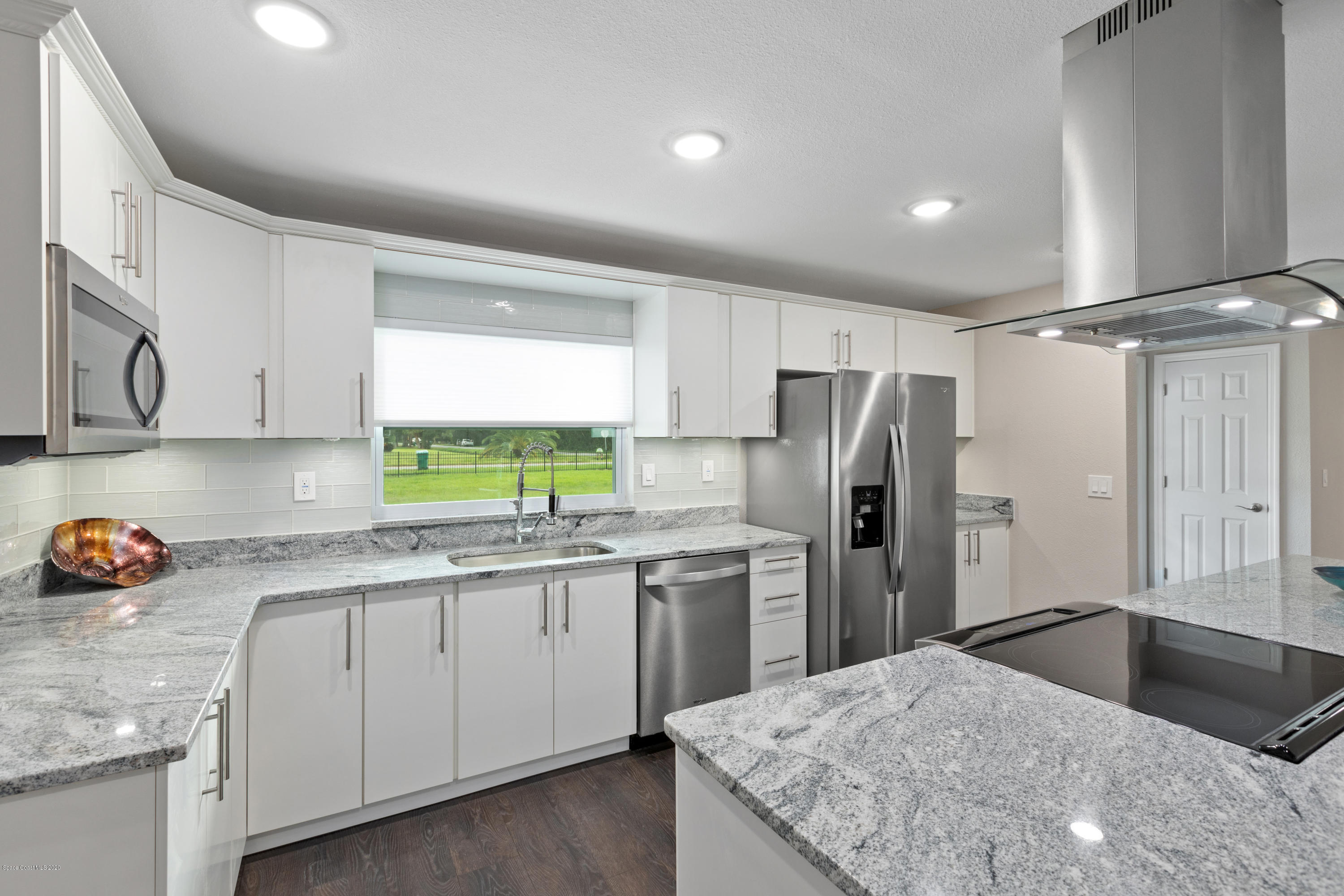 1790 Harlock Road Melbourne, FL 32934 - Photo 5 of 47 a kitchen with a sink stove and refrigerator