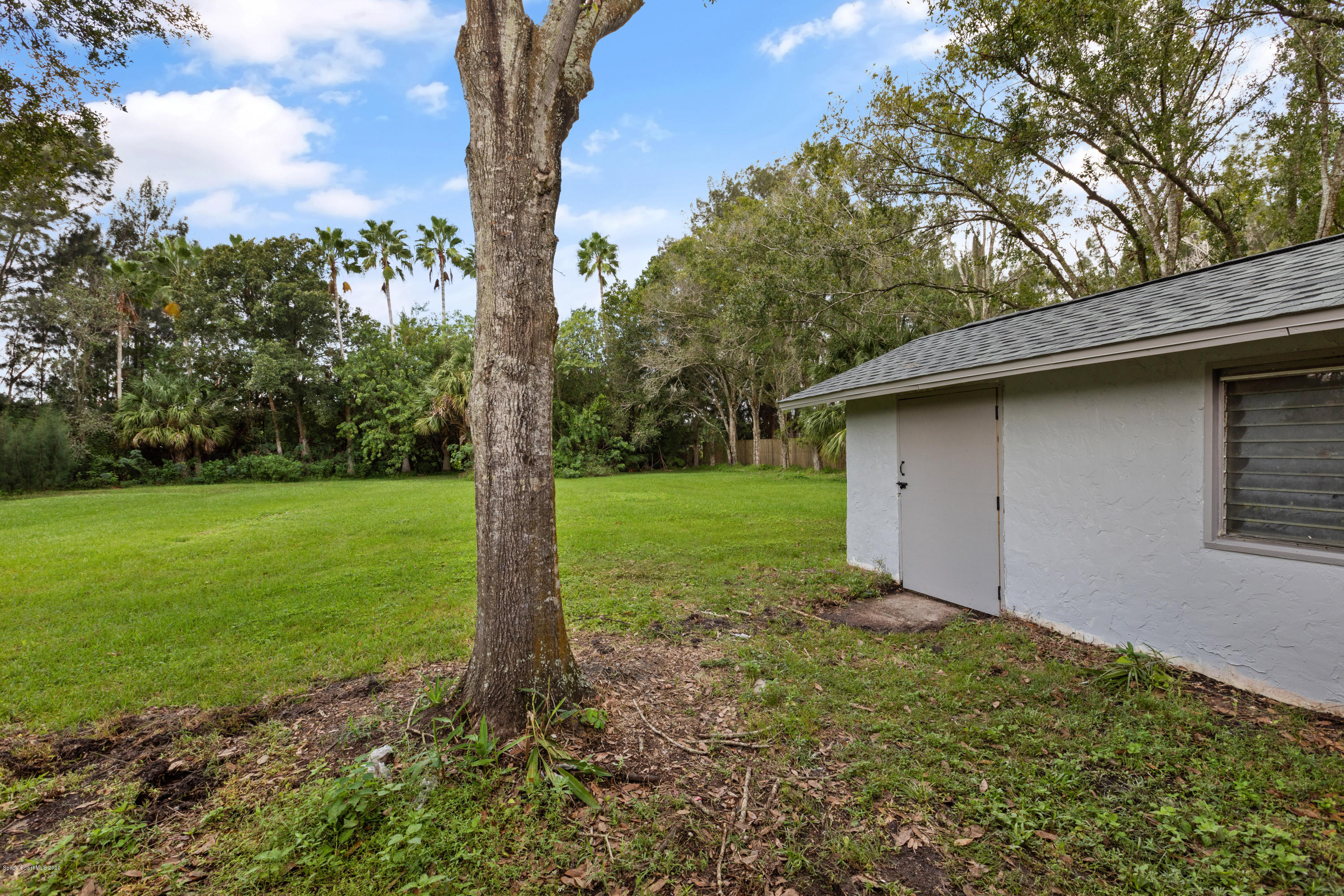 1790 Harlock Road Melbourne, FL 32934 - Photo 43 of 47 a view of a backyard with large trees