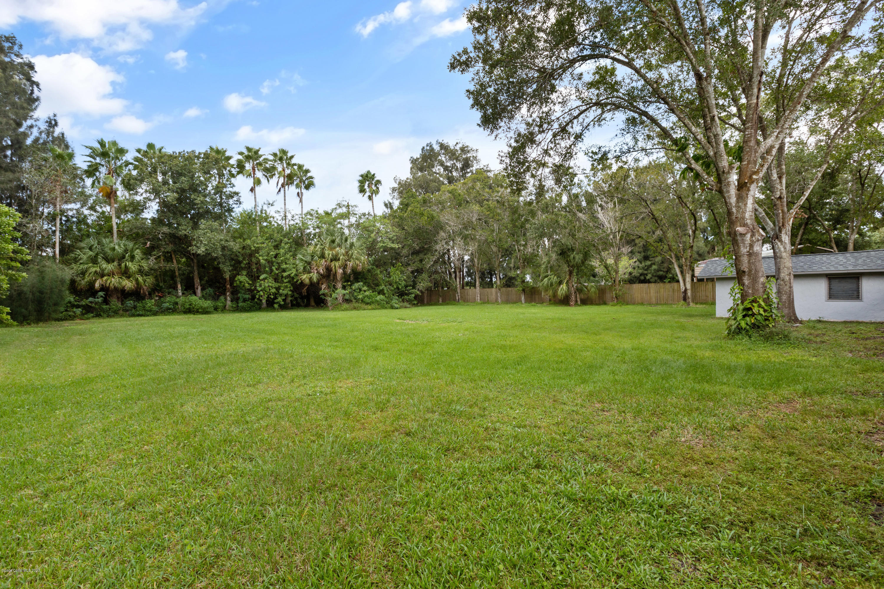 1790 Harlock Road Melbourne, FL 32934 - Photo 47 of 47 a view of a green field with trees in the background