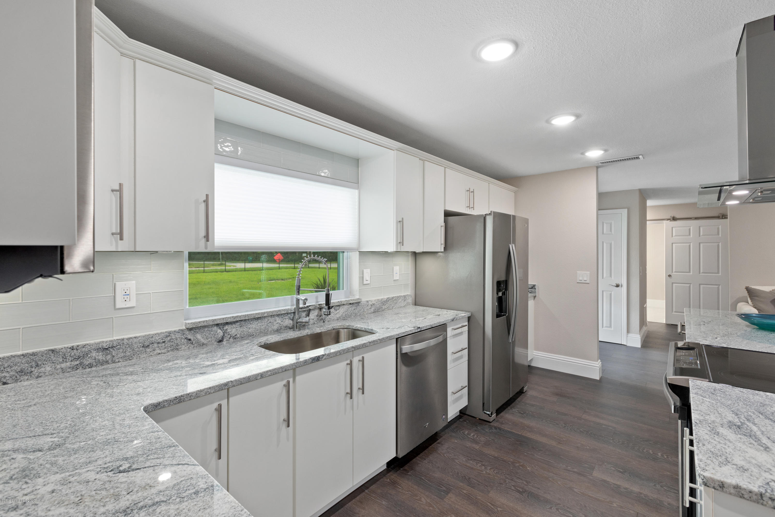 1790 Harlock Road Melbourne, FL 32934 - Photo 6 of 47 a kitchen with a sink a refrigerator and window