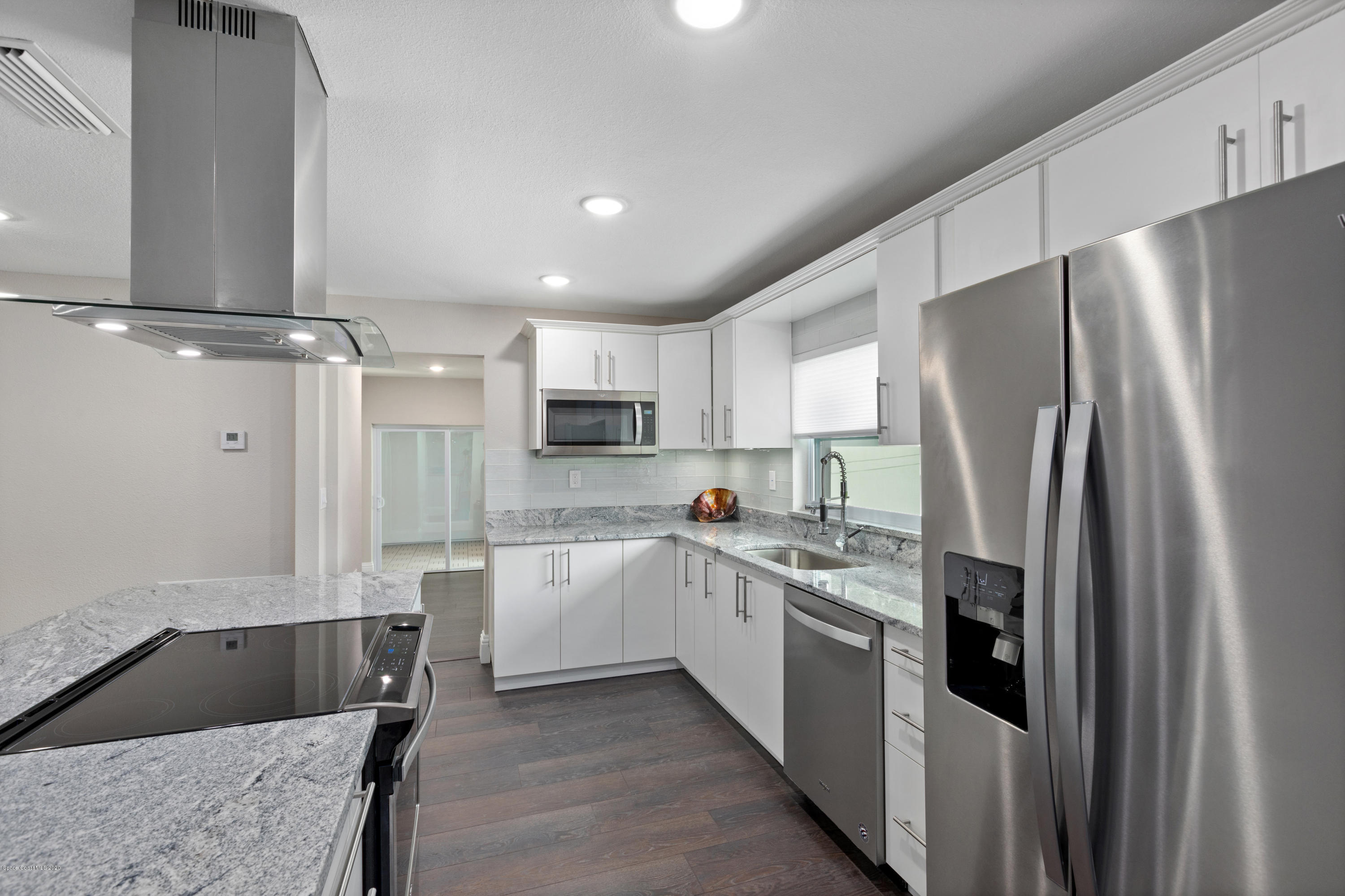 1790 Harlock Road Melbourne, FL 32934 - Photo 8 of 47 a kitchen with stainless steel appliances a refrigerator sink and microwave