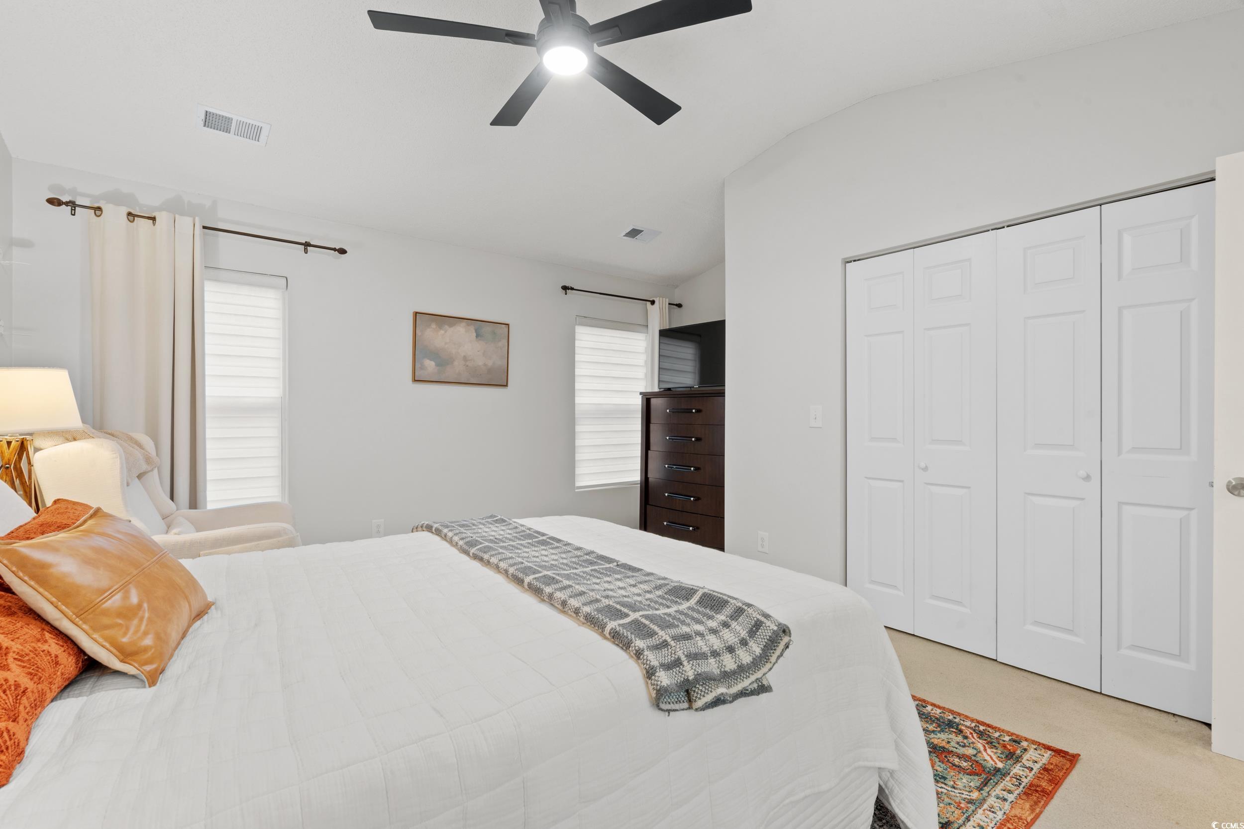 104 Olde Towne Way, Unit 5 Myrtle Beach, SC 29588 - Photo 20 of 24 Bedroom featuring lofted ceiling, light carpet, a ceiling fan, and a closet