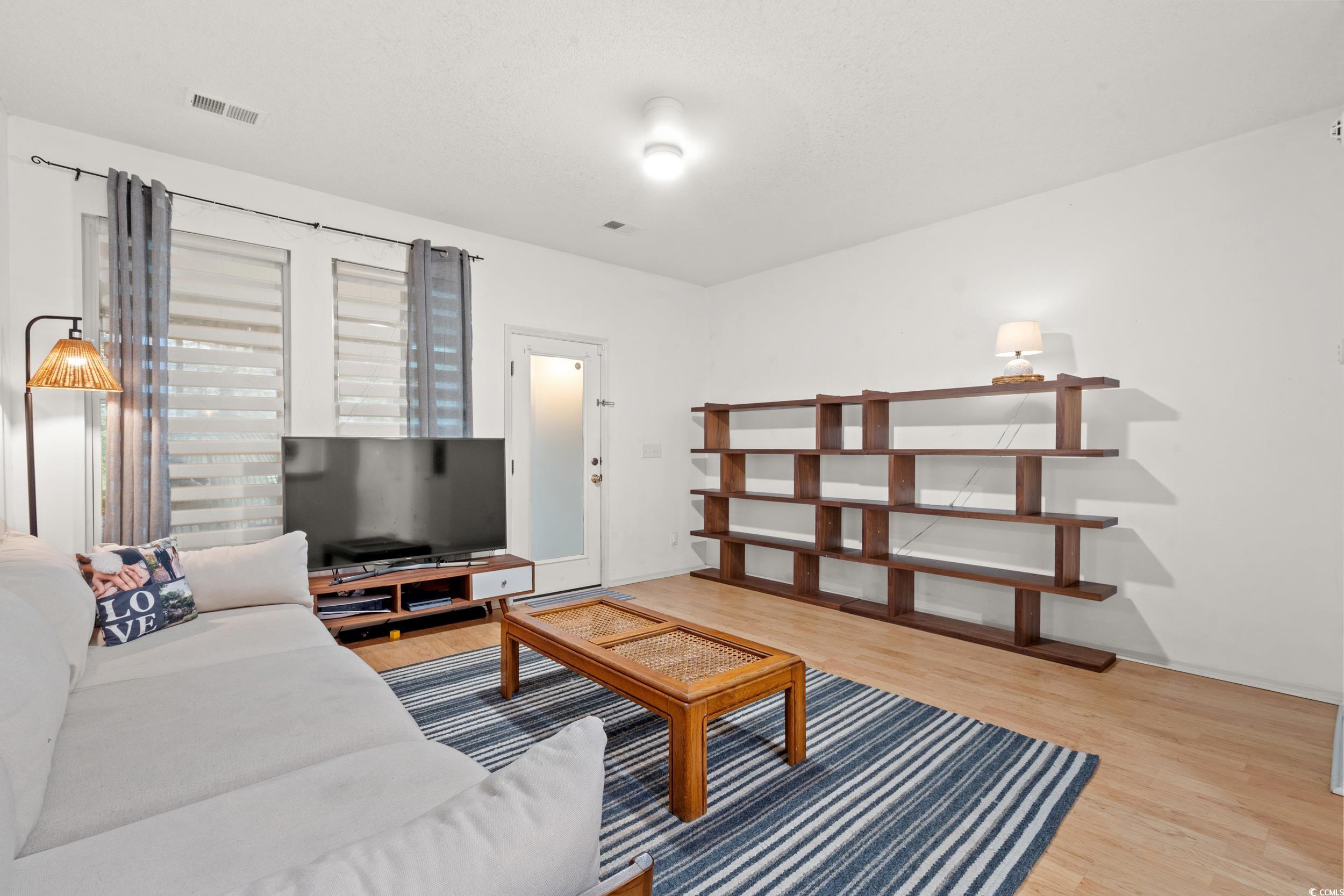104 Olde Towne Way, Unit 5 Myrtle Beach, SC 29588 - Photo 8 of 24 Living area featuring light wood-style flooring