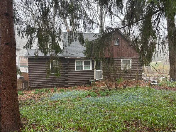 a view of house with backyard