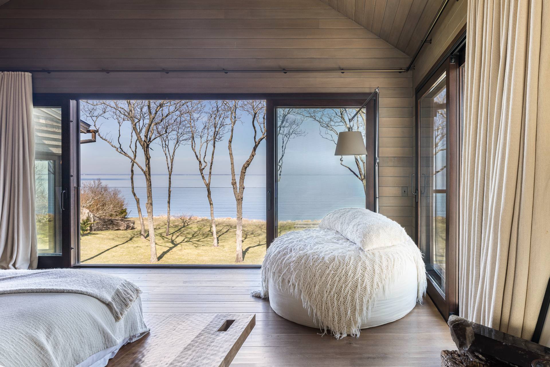 54 Hedges Banks Drive East Hampton, NY 11937 - Photo 13 of 24 a bed sitting in a bedroom next to a window