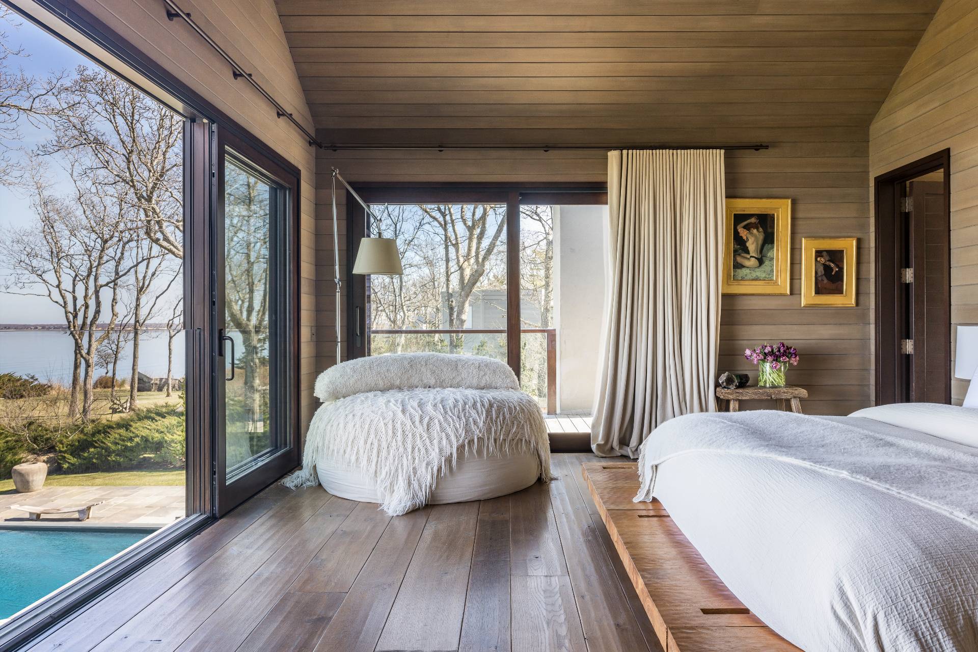 54 Hedges Banks Drive East Hampton, NY 11937 - Photo 14 of 24 a bedroom with a bed and wooden floor