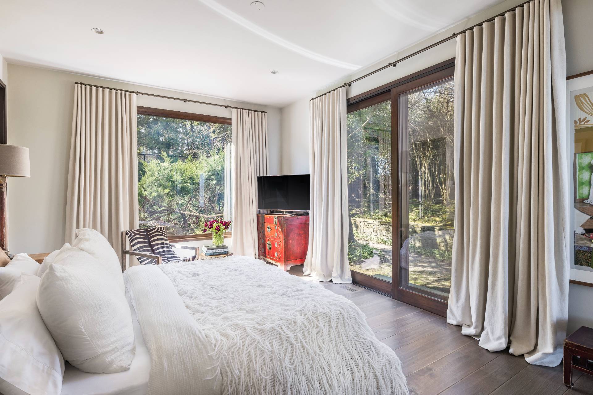 54 Hedges Banks Drive East Hampton, NY 11937 - Photo 20 of 24 a bedroom with a bed and a large window with outer view