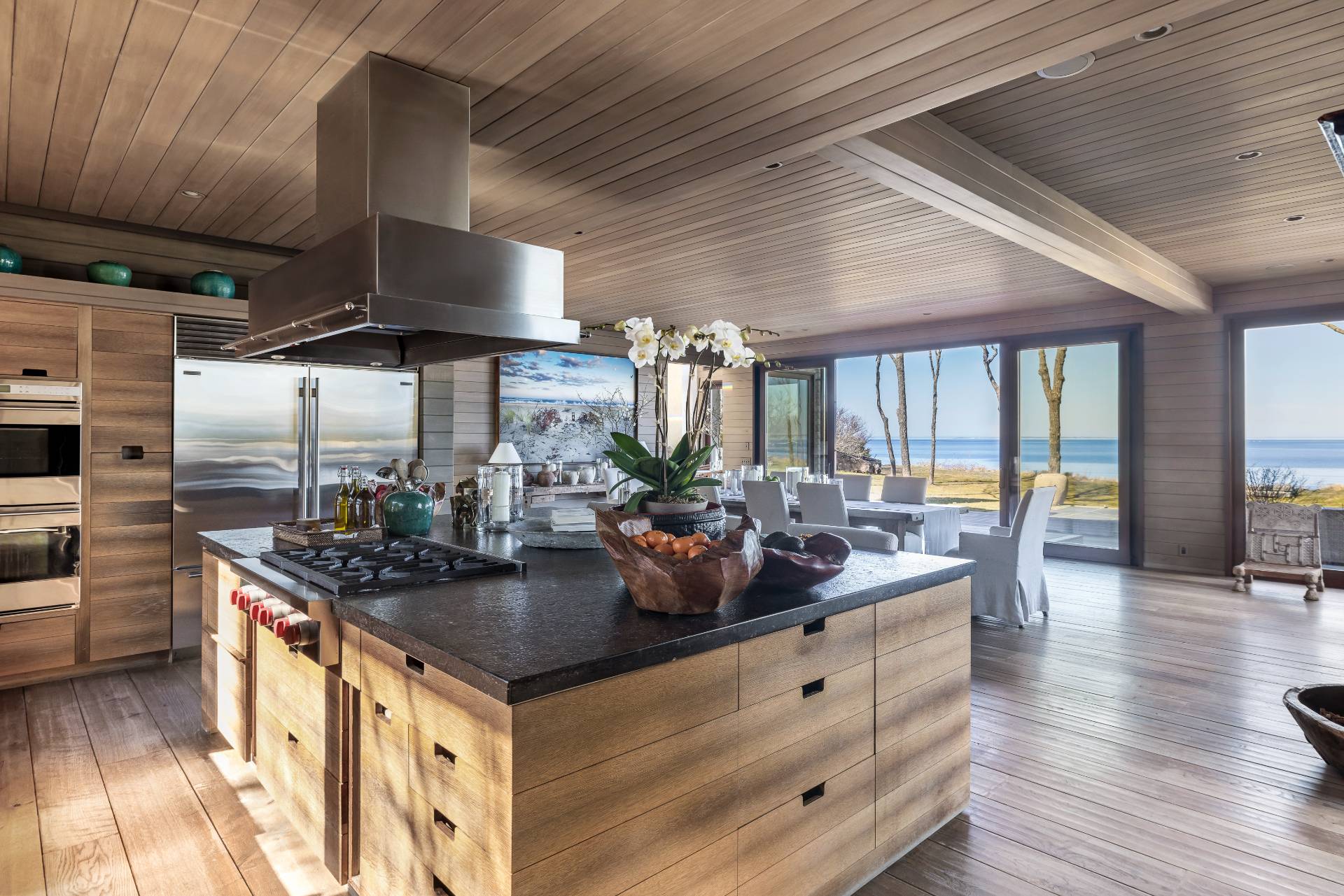 54 Hedges Banks Drive East Hampton, NY 11937 - Photo 4 of 24 a kitchen with stainless steel appliances granite countertop a sink a stove and a wooden floors
