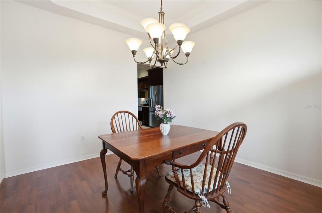 14228 Presteign Lane Spring Hill, FL 34609 - Photo 35 of 89 a dining room with a table chairs and wooden floor