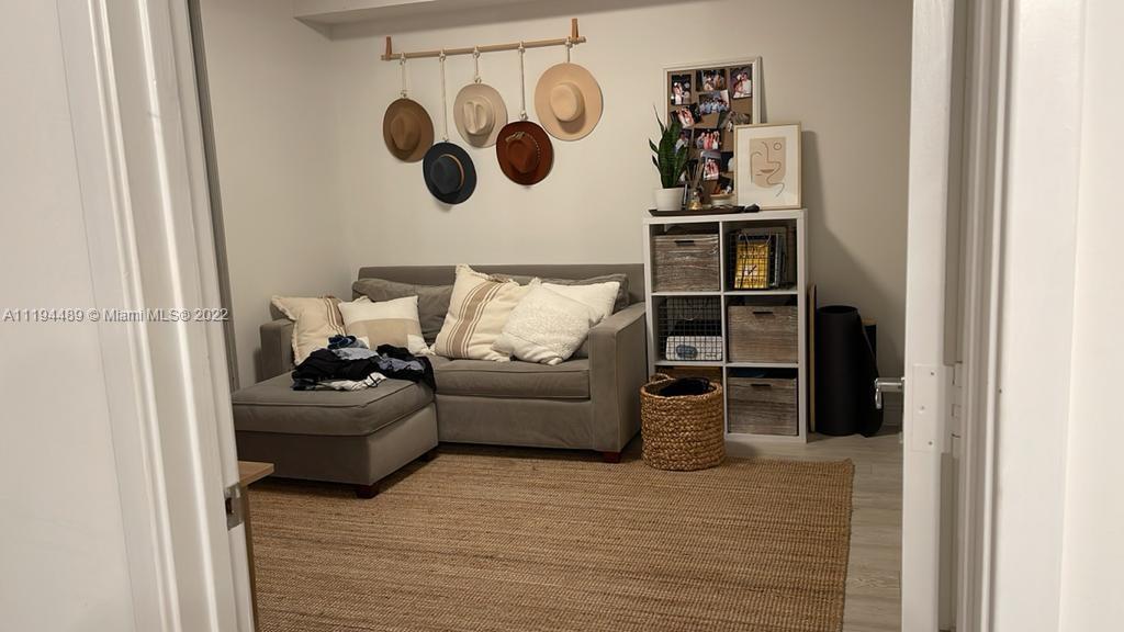 185 Southwest 7th Street, Unit 2703 Miami, FL 33130 - Photo 13 of 16 a living room with furniture and wooden floor