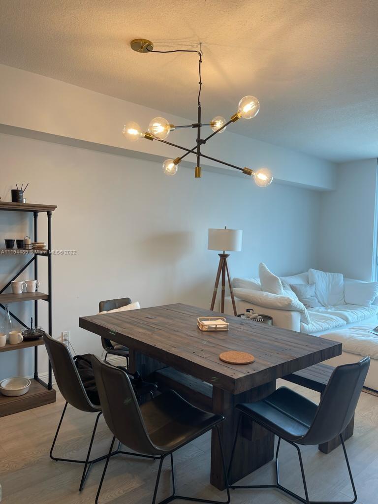 185 Southwest 7th Street, Unit 2703 Miami, FL 33130 - Photo 4 of 16 a view of a dining room with furniture