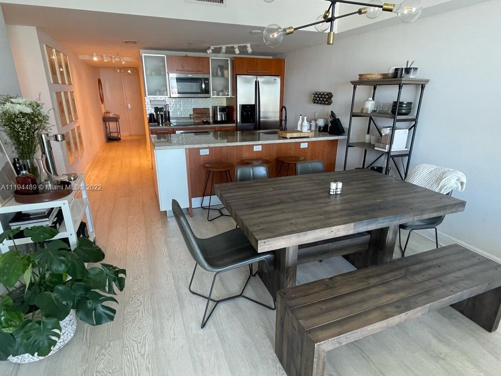 185 Southwest 7th Street, Unit 2703 Miami, FL 33130 - Photo 5 of 16 a view of a dining room with furniture