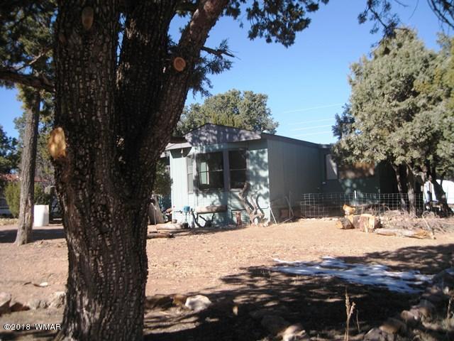 2122 Cottontail Road Overgaard, AZ 85933 - Photo 1 of 7 a view of a yard covered in snow