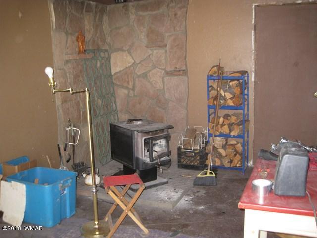 2122 Cottontail Road Overgaard, AZ 85933 - Photo 3 of 7 a living room with furniture and a fireplace
