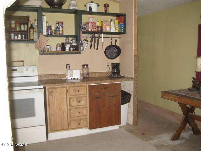 2122 Cottontail Road Overgaard, AZ 85933 - Photo 6 of 7 a kitchen with a sink a stove and cabinets