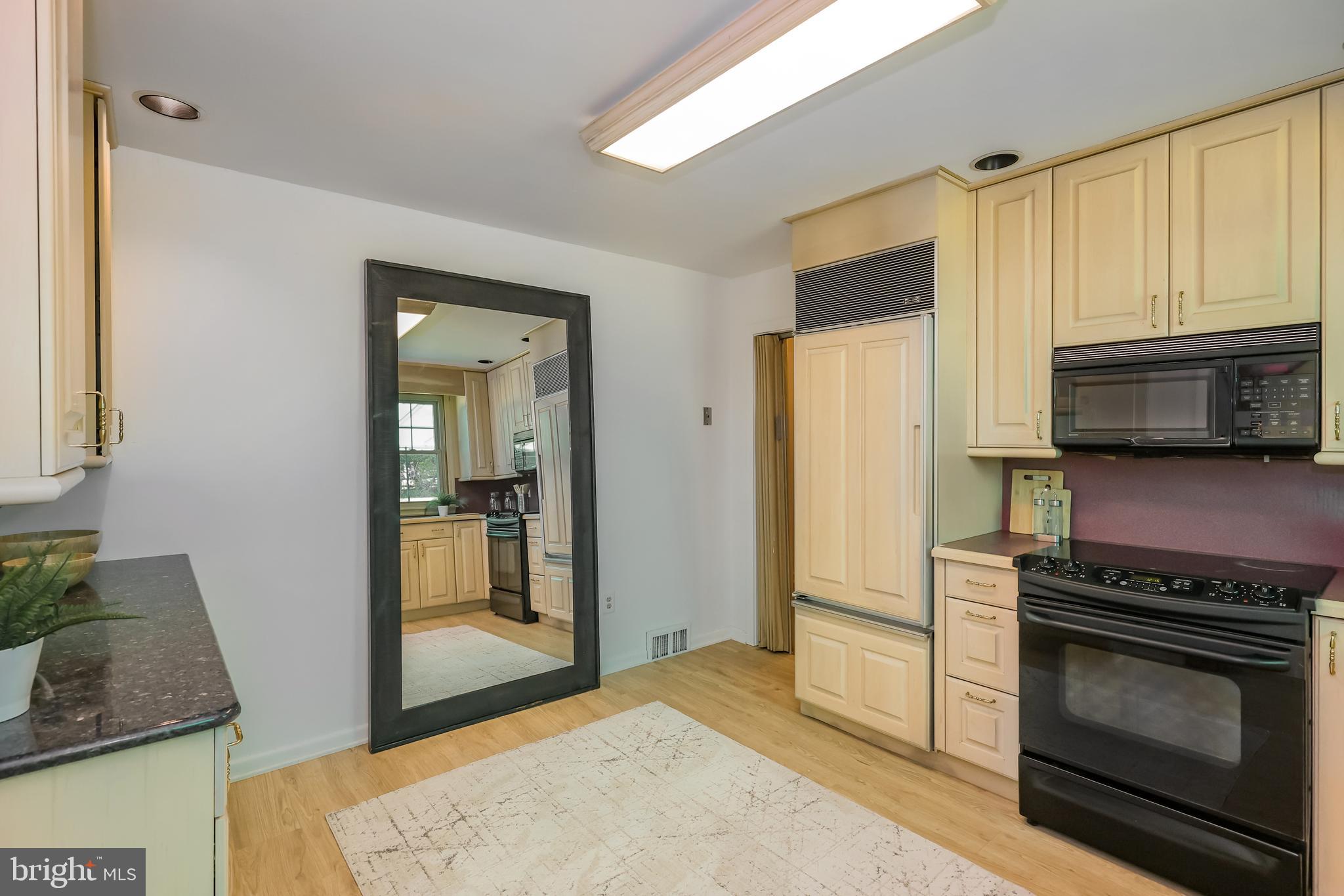 262 Ellis Road Havertown, PA 19083 - Photo 18 of 41 a kitchen with granite countertop wooden cabinets and stainless steel appliances