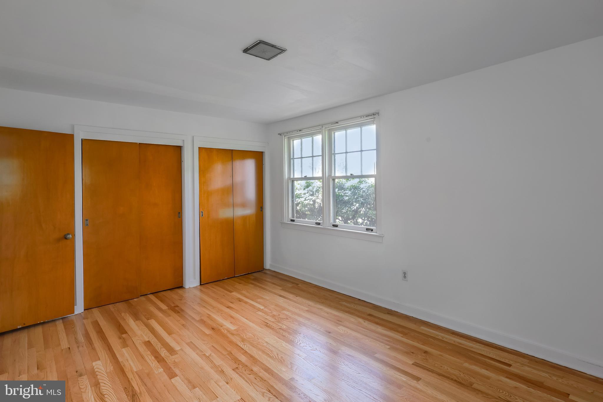 262 Ellis Road Havertown, PA 19083 - Photo 27 of 41 an empty room with wooden floor and windows