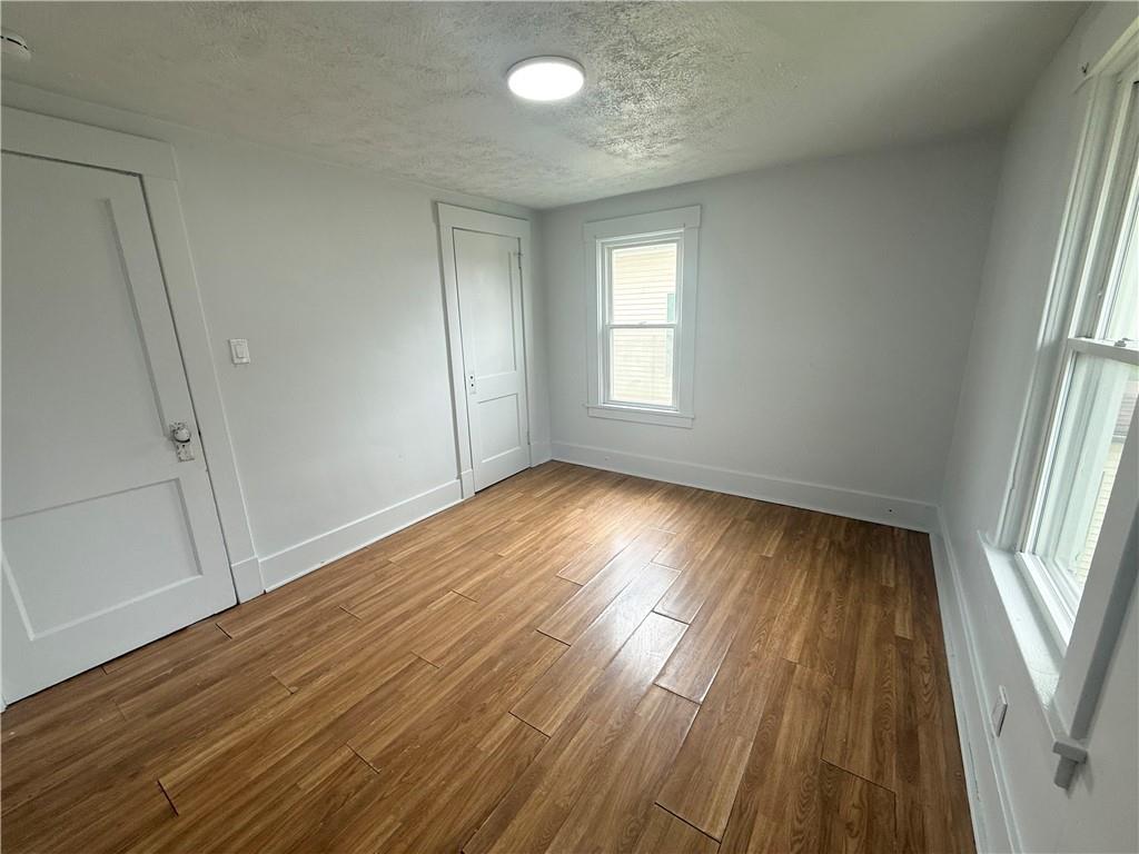 726 Baldwin Avenue Sharon, PA 16146 - Photo 11 of 11 an empty room with wooden floor and windows