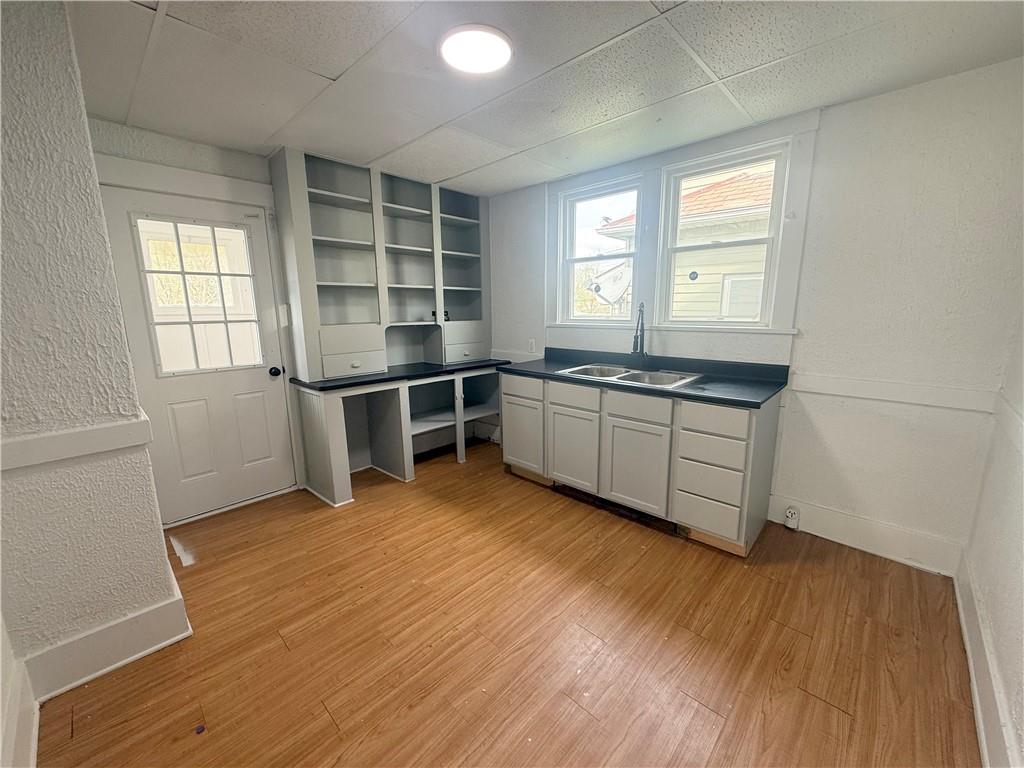 726 Baldwin Avenue Sharon, PA 16146 - Photo 4 of 11 an empty room with wooden floor and windows