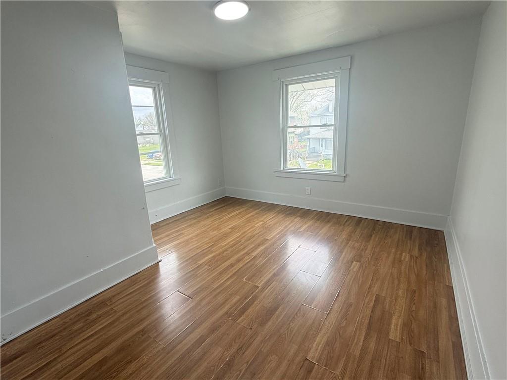 726 Baldwin Avenue Sharon, PA 16146 - Photo 10 of 11 a view of an empty room with wooden floor and a window